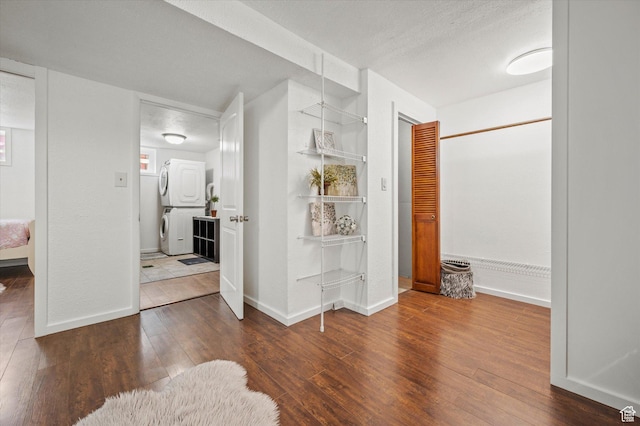 430 W 550 N, Logan, UT 84321 - corridor with stacked washing machine and dryer, hardwood / wood-style flooring, baseboards, and a textured ceiling