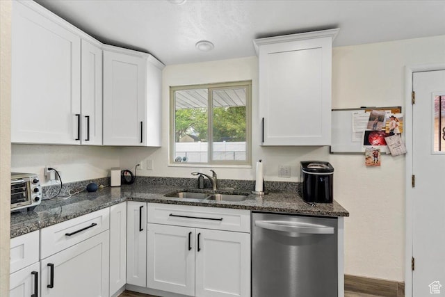 5680 S 2600 W Unit 12, Roy, UT 84067 - kitchen featuring stainless steel dishwasher, a sink, white cabinetry, and dark stone counters