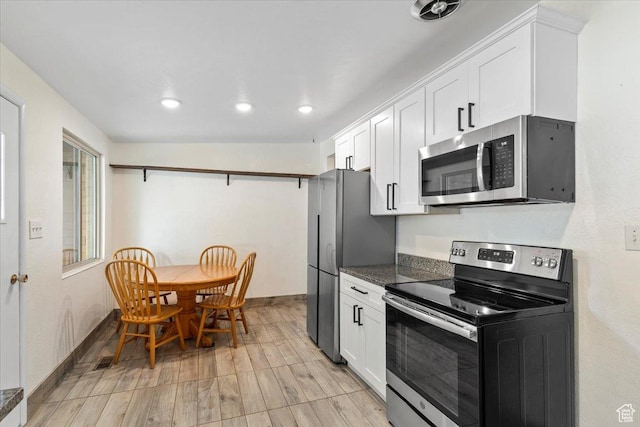 5680 S 2600 W Unit 12, Roy, UT 84067 - kitchen featuring appliances with stainless steel finishes, white cabinets, baseboards, recessed lighting, and light wood finished floors