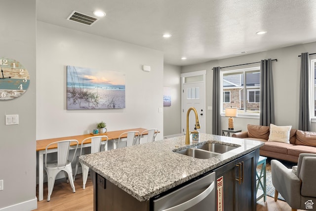 150 W Seasons Loop Unit 3, Garden City, UT 84028 - kitchen featuring a sink, dishwasher, open floor plan, light wood finished floors, and an island with sink