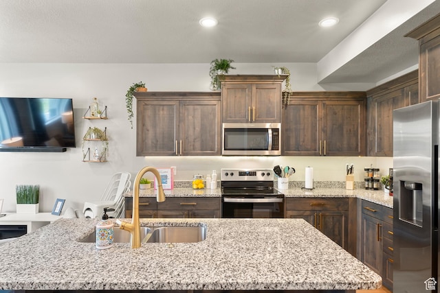 150 W Seasons Loop Unit 3, Garden City, UT 84028 - kitchen featuring stainless steel appliances, a sink, an island with sink, dark brown cabinetry, and recessed lighting