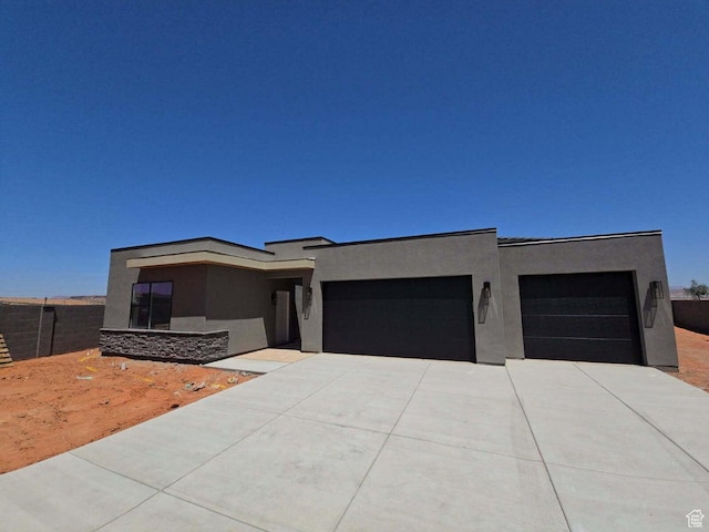 3719 E Padre Cv Unit 4092, Washington, UT 84780 - contemporary house featuring stucco siding, a garage, and driveway