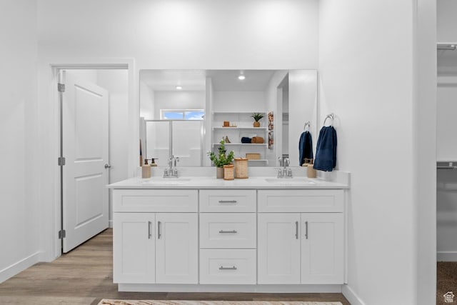 3719 E Padre Cv Unit 4092, Washington, UT 84780 - bathroom with double vanity, a walk in closet, baseboards, and wood finished floors
