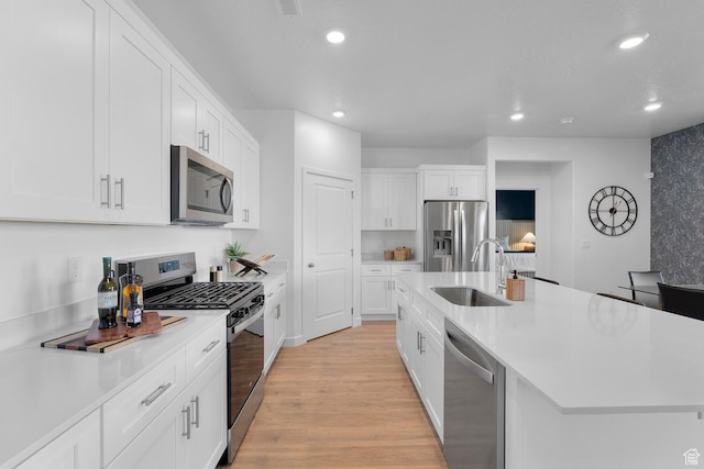 3719 E Padre Cv Unit 4092, Washington, UT 84780 - kitchen with appliances with stainless steel finishes, a sink, recessed lighting, light wood-style flooring, and light countertops
