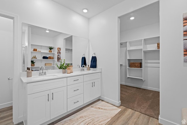 3719 E Padre Cv Unit 4092, Washington, UT 84780 - full bath featuring a walk in closet, double vanity, wood finished floors, baseboards, and recessed lighting