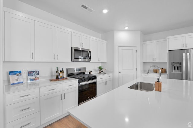 3719 E Padre Cv Unit 4092, Washington, UT 84780 - kitchen featuring stainless steel appliances, a sink, light countertops, recessed lighting, and white cabinets
