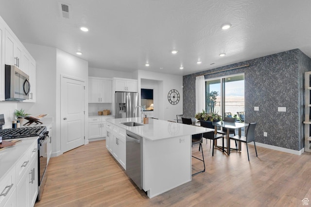 3719 E Padre Cv Unit 4092, Washington, UT 84780 - kitchen with stainless steel appliances, a sink, recessed lighting, an island with sink, and light wood-type flooring