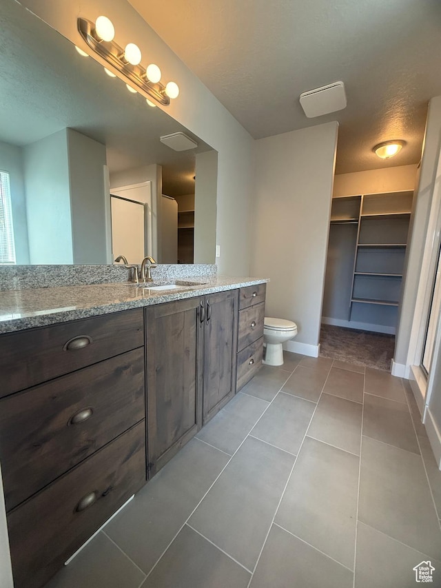 268 S 400 W, Tooele, UT 84074 - full bath featuring vanity, baseboards, tile patterned flooring, and toilet