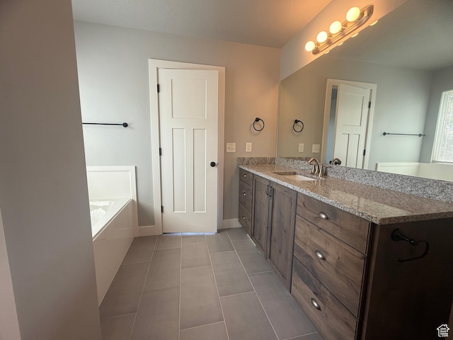 268 S 400 W, Tooele, UT 84074 - bathroom featuring vanity, tile patterned floors, a garden tub, and baseboards