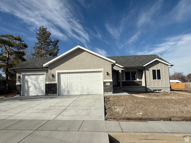 268 S 400 W, Tooele, UT 84074 - ranch-style house with a garage, driveway, a shingled roof, and stone siding