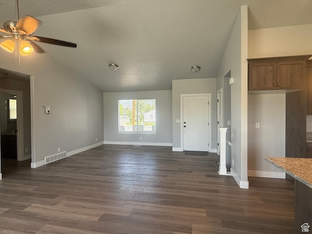 268 S 400 W, Tooele, UT 84074 - unfurnished living room featuring vaulted ceiling, baseboards, ceiling fan, and dark wood-type flooring
