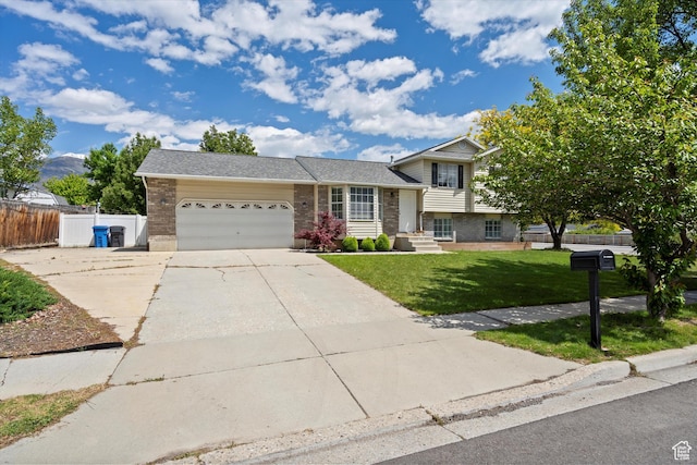 714 N 300 W, American Fork, UT 84003 - split level home with brick siding, an attached garage, concrete driveway, and roof with shingles