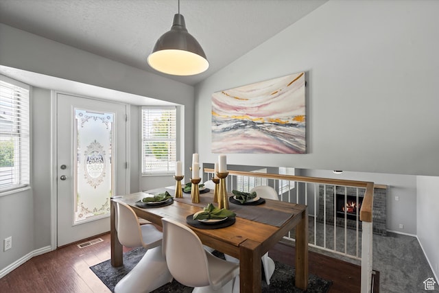 714 N 300 W, American Fork, UT 84003 - dining room with plenty of natural light, vaulted ceiling, wood finished floors, a fireplace, and baseboards