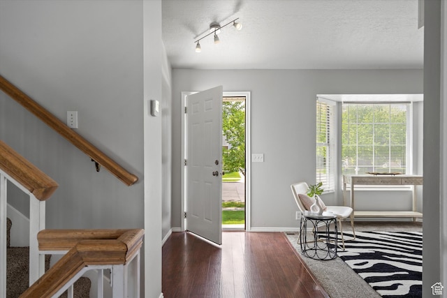 714 N 300 W, American Fork, UT 84003 - entryway featuring healthy amount of natural light, wood finished floors, baseboards, and a textured ceiling