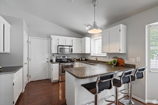 714 N 300 W, American Fork, UT 84003 - kitchen with stainless steel appliances, a sink, dark countertops, white cabinetry, and a peninsula