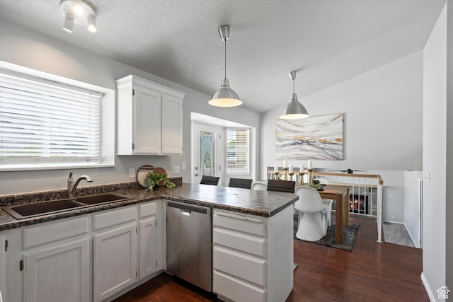 714 N 300 W, American Fork, UT 84003 - kitchen with stainless steel dishwasher, a sink, dark countertops, a peninsula, and white cabinets
