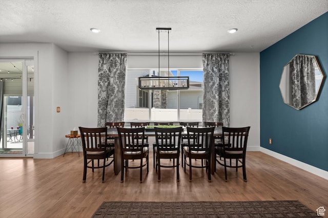1067 W Ludington Ct, Bluffdale, UT 84065 - dining room featuring wood finished floors, baseboards, a textured ceiling, a chandelier, and recessed lighting