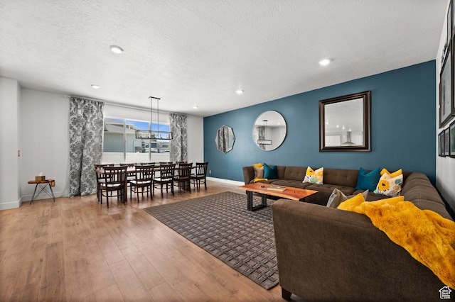 1067 W Ludington Ct, Bluffdale, UT 84065 - living area featuring baseboards, wood finished floors, a textured ceiling, and recessed lighting