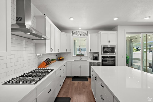 1067 W Ludington Ct, Bluffdale, UT 84065 - kitchen featuring wall chimney range hood, stainless steel appliances, light countertops, white cabinetry, and recessed lighting