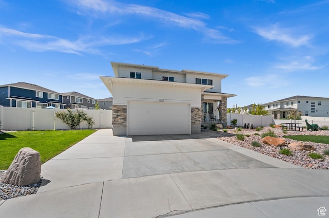 1067 W Ludington Ct, Bluffdale, UT 84065 - view of front of property featuring stone siding, concrete driveway, a residential view, and an attached garage