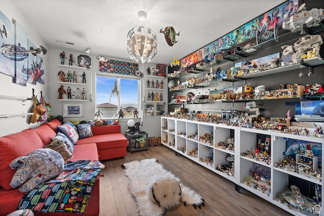 1067 W Ludington Ct, Bluffdale, UT 84065 - sitting room with hardwood / wood-style floors, a chandelier, and a textured ceiling