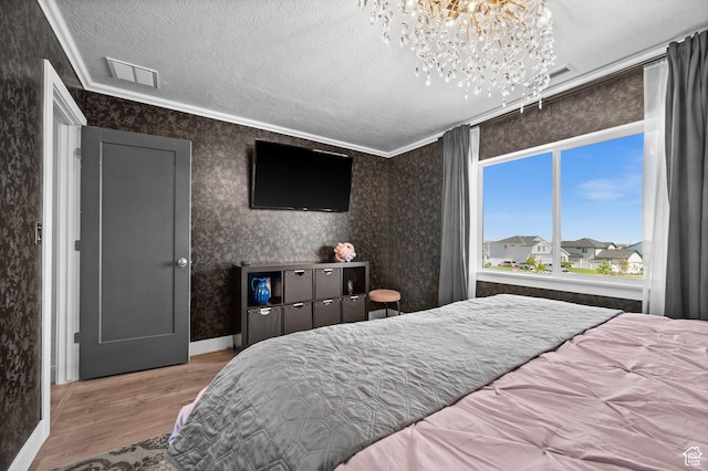 1067 W Ludington Ct, Bluffdale, UT 84065 - bedroom with wood finished floors, a chandelier, a textured ceiling, wallpapered walls, and crown molding