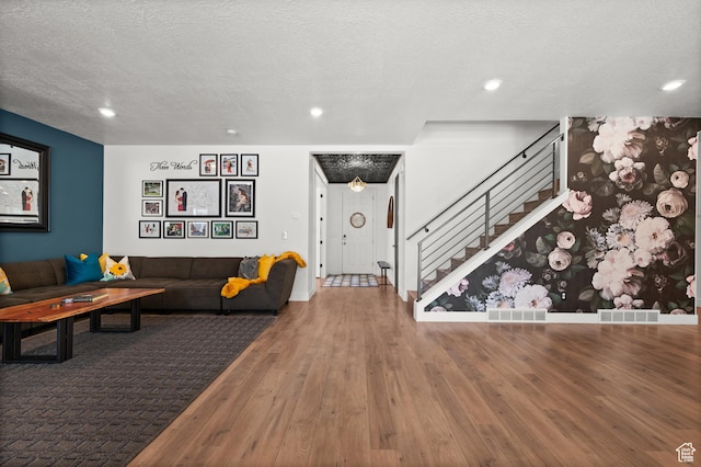 1067 W Ludington Ct, Bluffdale, UT 84065 - living area featuring wood finished floors, stairs, a textured ceiling, recessed lighting, and baseboards