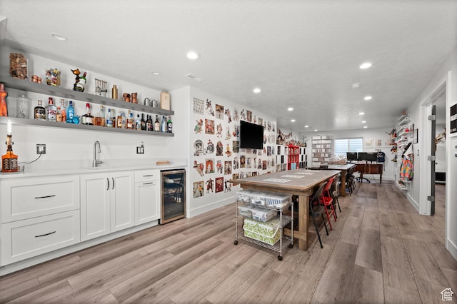 1067 W Ludington Ct, Bluffdale, UT 84065 - kitchen with wine cooler, open shelves, recessed lighting, light wood finished floors, and a sink