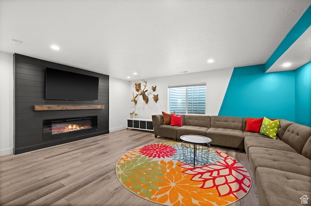 1067 W Ludington Ct, Bluffdale, UT 84065 - living room with wood finished floors, a large fireplace, baseboards, and recessed lighting