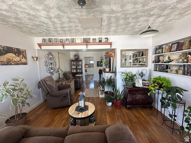 110 S 200 E, Cleveland, UT 84518 - living area with wood finished floors, baseboards, and a textured ceiling