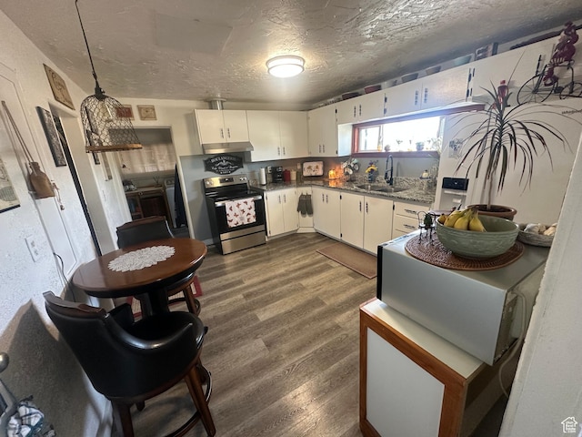 110 S 200 E, Cleveland, UT 84518 - kitchen featuring electric range, a sink, under cabinet range hood, dark wood-style flooring, and white cabinetry