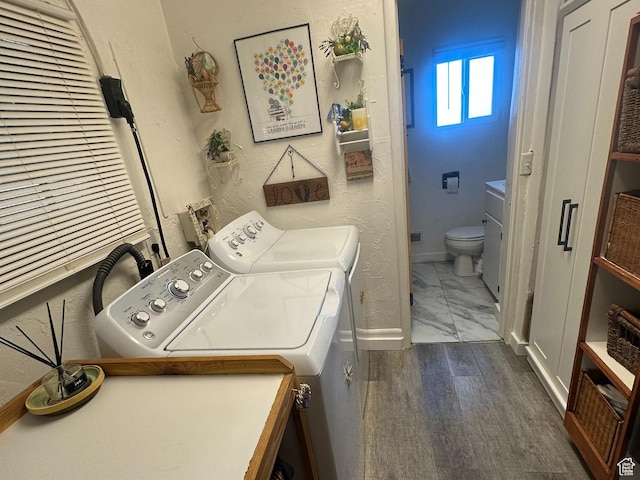 110 S 200 E, Cleveland, UT 84518 - laundry area featuring washer and dryer, baseboards, and wood finished floors