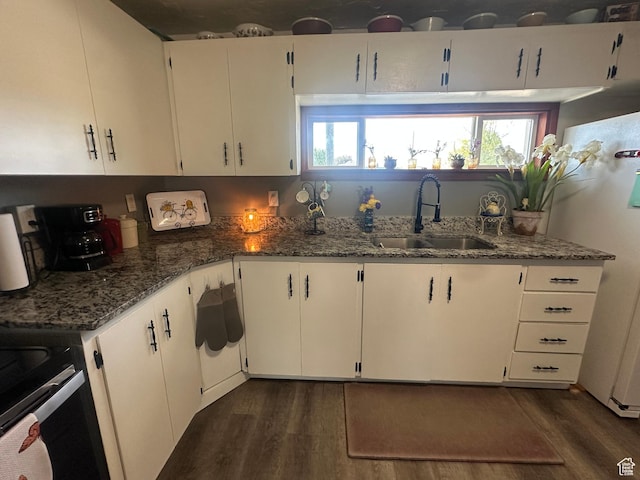 110 S 200 E, Cleveland, UT 84518 - kitchen featuring a sink, dark wood-type flooring, dark stone countertops, and plenty of natural light