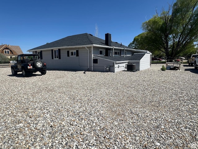 110 S 200 E, Cleveland, UT 84518 - view of property exterior featuring a chimney, a shingled roof, and central AC