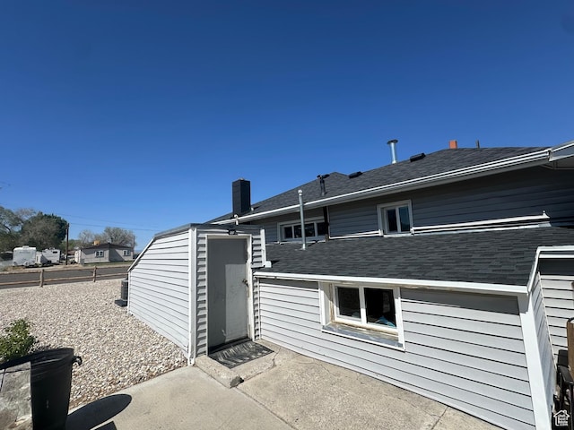 110 S 200 E, Cleveland, UT 84518 - back of house with a patio, a chimney, and roof with shingles