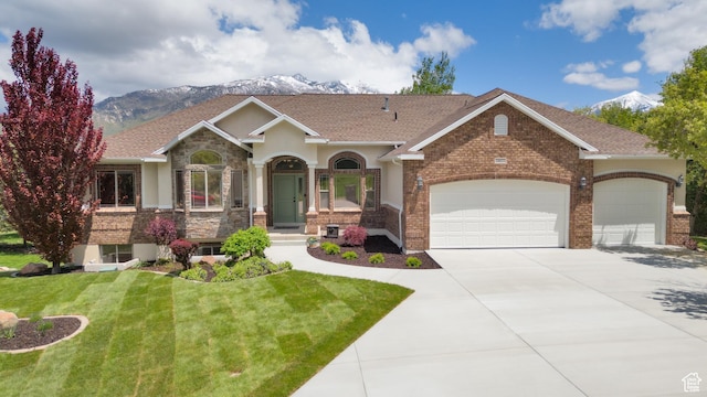 14825 S Meadow Oak Ct, Draper, UT 84020 - view of front of home with driveway, an attached garage, a front lawn, a mountain view, and stucco siding