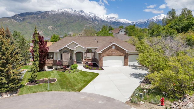 14825 S Meadow Oak Ct, Draper, UT 84020 - view of front of home featuring a garage, concrete driveway, a front lawn, a mountain view, and brick siding
