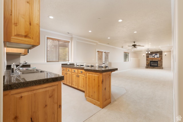 14825 S Meadow Oak Ct, Draper, UT 84020 - kitchen featuring a sink, ornamental molding, a ceiling fan, recessed lighting, and a stone fireplace