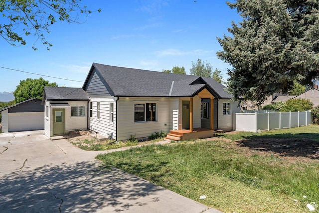 905 N 100 E, Pleasant Grove, UT 84062 - view of front of house featuring an outbuilding, a shingled roof, a detached garage, and driveway