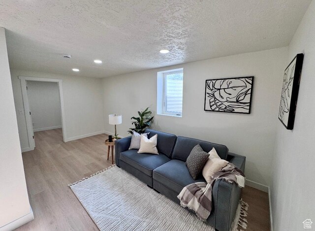 5011 S Leisure Ln W, Taylorsville, UT 84129 - living room featuring a textured ceiling, light wood-type flooring, baseboards, and recessed lighting