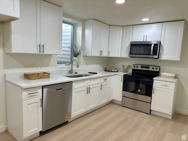5011 S Leisure Ln W, Taylorsville, UT 84129 - kitchen featuring stainless steel appliances, a sink, white cabinetry, light countertops, and recessed lighting