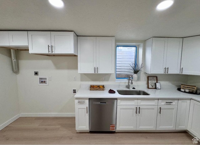 5011 S Leisure Ln W, Taylorsville, UT 84129 - kitchen featuring dishwasher, a sink, white cabinets, light wood-style flooring, and baseboards