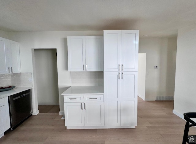 5011 S Leisure Ln W, Taylorsville, UT 84129 - kitchen featuring dishwashing machine, light wood-type flooring, white cabinets, and backsplash