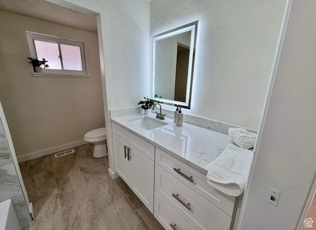 5011 S Leisure Ln W, Taylorsville, UT 84129 - bathroom featuring toilet, vanity, and baseboards