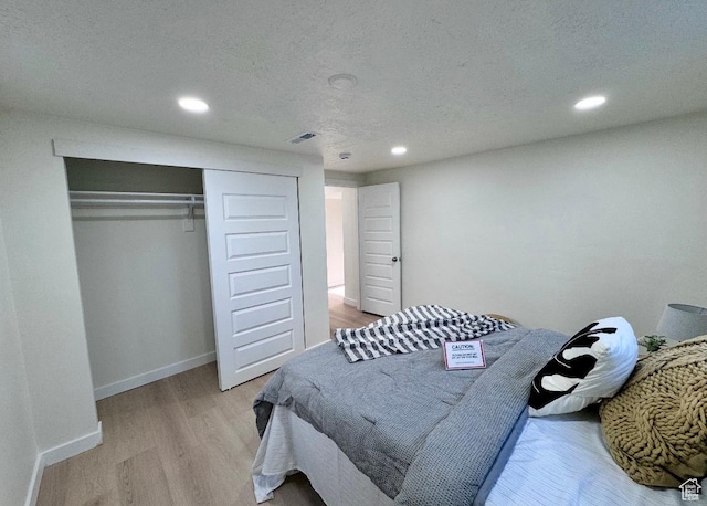 5011 S Leisure Ln W, Taylorsville, UT 84129 - bedroom with recessed lighting, light wood-style flooring, a closet, baseboards, and a textured ceiling