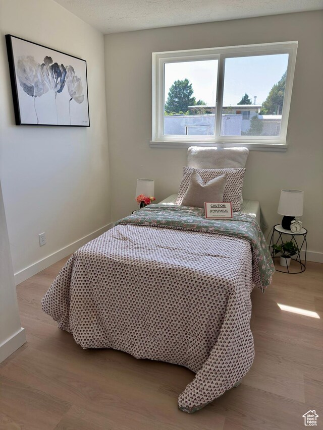 5011 S Leisure Ln W, Taylorsville, UT 84129 - bedroom with baseboards and wood finished floors