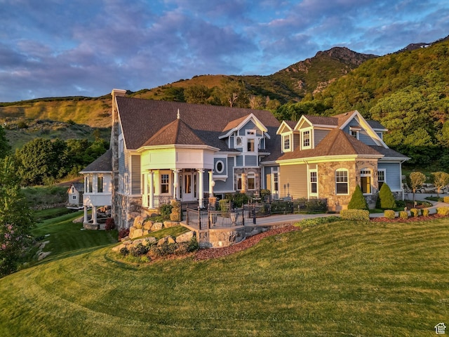 3291 E 1300 N, Layton, UT 84040 - view of front of home with a patio, a front yard, a mountain view, and stone siding