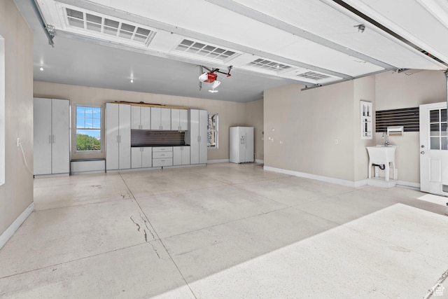 3291 E 1300 N, Layton, UT 84040 - garage with baseboards, a garage door opener, a sink, and white refrigerator with ice dispenser