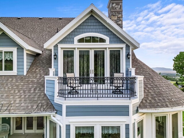 3291 E 1300 N, Layton, UT 84040 - view of side of home featuring a balcony, roof with shingles, and french doors