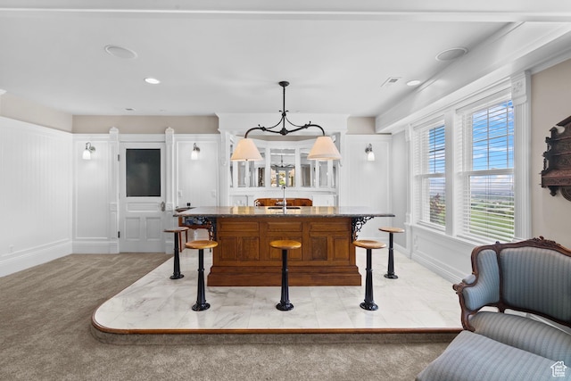 3291 E 1300 N, Layton, UT 84040 - kitchen with a center island with sink, a kitchen bar, a chandelier, light colored carpet, and decorative light fixtures